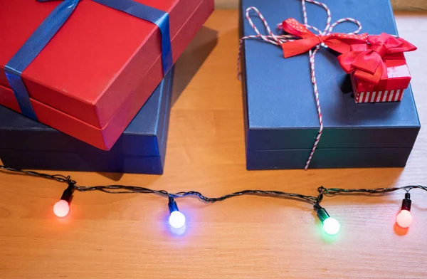 few boxes on a desk with Christmas garland. high angle closeup indoor shot