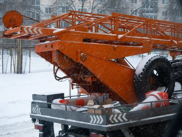 city repairing utility construction crane with orange road cones at winter season