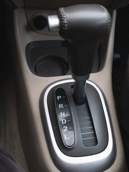 gear lever automatic transmission closeup. selective focus on drive modes. low key image