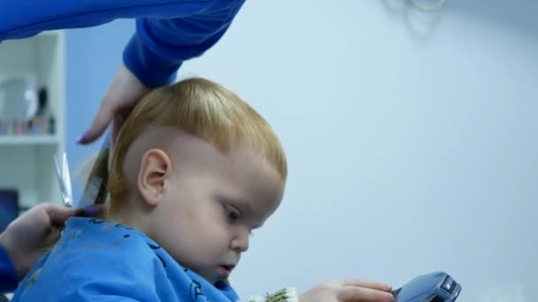 Barber Cutting Hair Backhead Year Old Cute Boy While Play — Stock Video