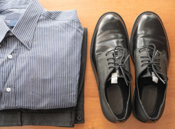 Everyday set of mans wear clothes for white collar worker - pants, formal shirt and pair of glossy shoes Royalty Free Stock Images