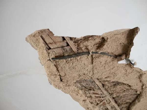 alçı sıva düşme ile ev tavanparçası. ahşap çubuklar ve kablolar görünür. görüntü kötü bina acil durum tasvir