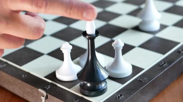 Schachfigur Schwarzer König Fällt Umgeben Von Drei Weißen Bauern Verloren — Stockvideo