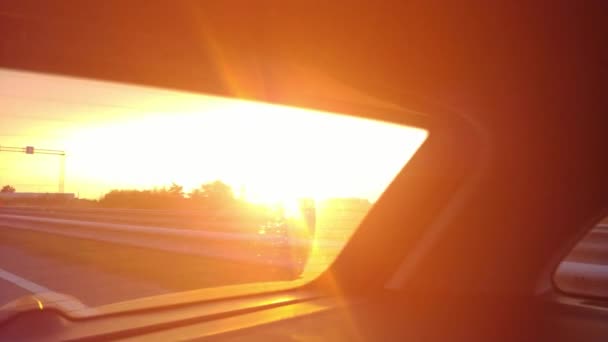 車の中で太陽を追いかける 後ろの車の窓から美しい夕日の景色 太陽が沈むとき 離れて移動する 4Kビデオ映像 — ストック動画