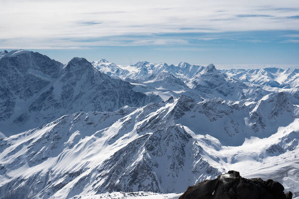 mountains in snow, blue sky, Sunny weather, white snow lying on the mountains