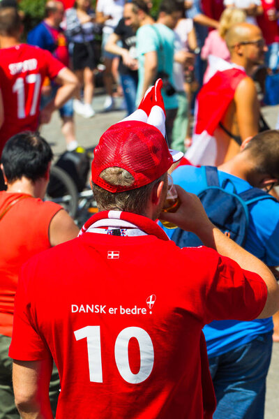 Russia, Moscow, June 26, 2018 - a crowd of Danish fans on the Manege Square near the Kremlin chanting and singing songs. Flag of Denmark. FIFA World Cup 2018.