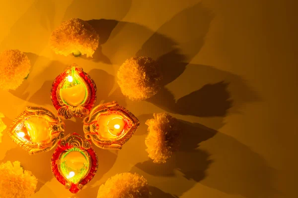 Indian festival Diwali, Diya oil lamps lit on colorful rangoli. — Stock Photo, Image