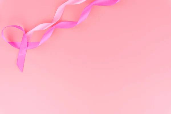 Pink ribbon breast cancer on pink background with copy space for — Stock Photo, Image