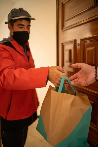 Delivery man delivers a food order that the customer ordered online