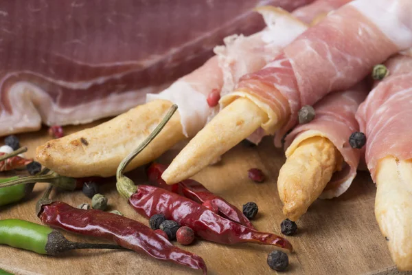 Grissini Bread Sticks Prosciutto Wooden Board Red Green Pepper — Stock Photo, Image