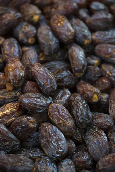 Pile of fresh dried date fruits on a traditional craftsman market. Fruit background. (selective focus)