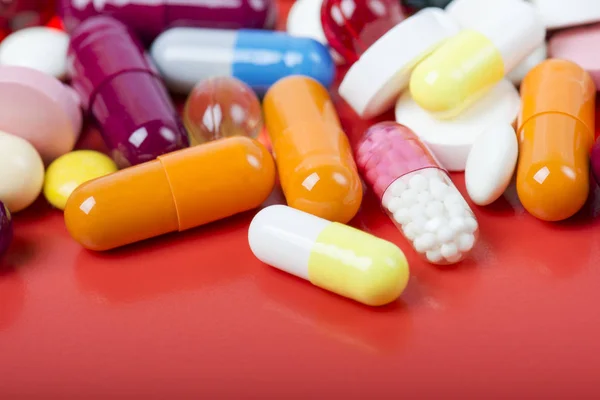 Colorful Pills Capsules Red Background — Stock Photo, Image