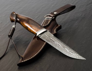 Siyah arka planda el yapımı avcı bıçağı. Deri Kaplama El Yapımı
