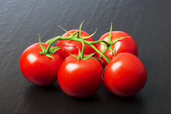 Branch Ripe Red Organic Tomatoes Green Leaves Black Background — Stock Photo, Image