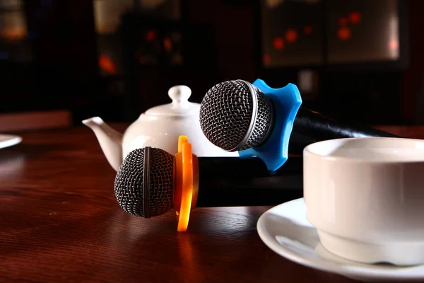 Dva Karaoke Mikrofony Jsou Stole Bílé Čajové Nádobí Koncept Restaurace — Stock fotografie