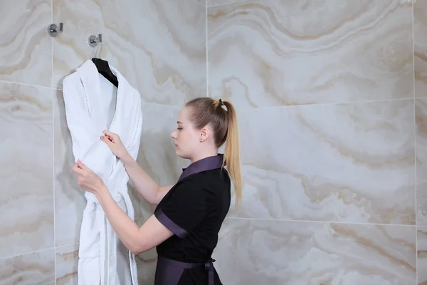 Ein Mädchen Putzuniform Passt Einen Weißen Mantel Der Der Wand — Stockfoto