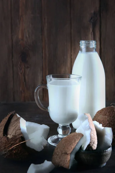 Split Coconuts Milk Bottle Tall Glass Dark Background Copy Space — Stock Photo, Image