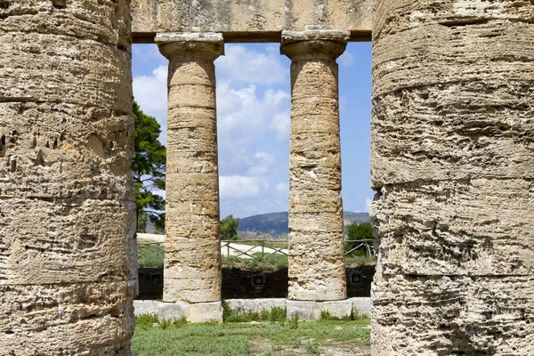 Ancient ruins of stone temple and nature, view from hilltop town of Segesta in Sicily, Italy.