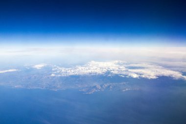 Bulutlarla kaplı dağlarda uçaktan hava manzarası
