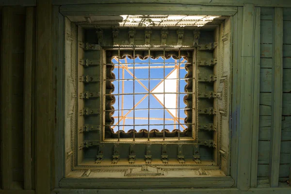 Ceiling with grid and sky view