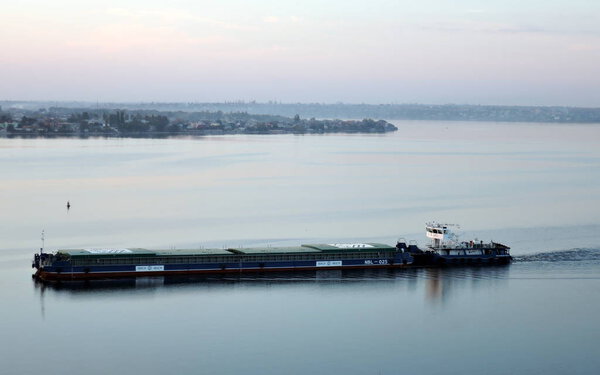 Ukraine, Nikolaev, Yuzhny Bug river. Tugboat and barges