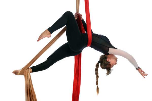 girl gymnast on aerial silk isolated on white background studio