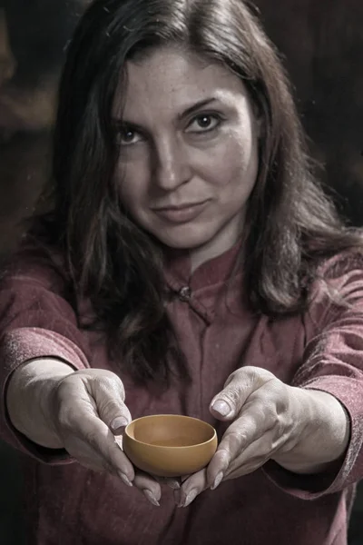 close-up portrait girl of a tea master in the studio against a dark background