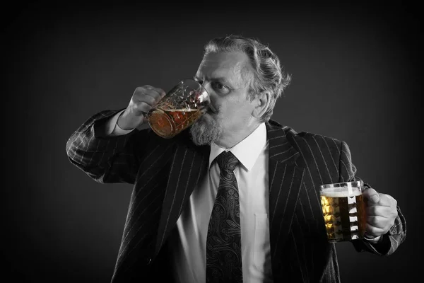 closeup portrait of an adult male with a mustache and beard, wearing glasses and a business suit with beer mug