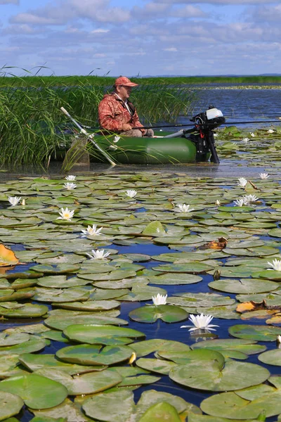 白いユリが湖でボートの漁師の夏の風景 — ストック写真