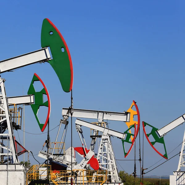 summer landscape oil pumps in a field on a clear sunny day