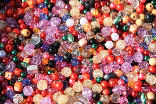 macro texture background colored beads of different shapes