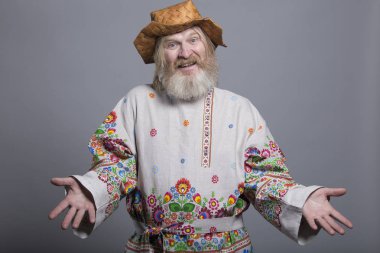 Slavic bearded man in a beautiful painted shirt and a birchbark hat clipart