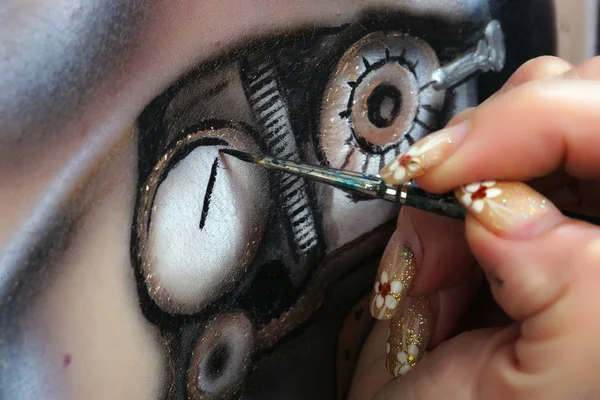 close-up of a woman\'s body painting, marionette doll with a mechanism on a black background Studio