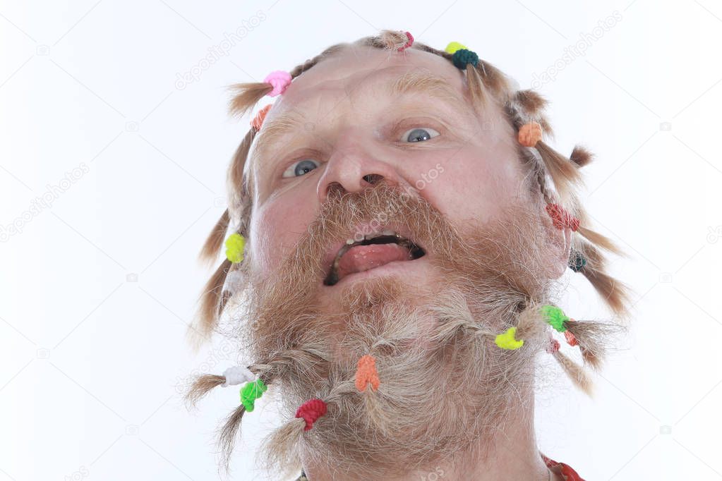 close-up portrait of a man with braids, mustache and beard in colored shirt on a white background studio