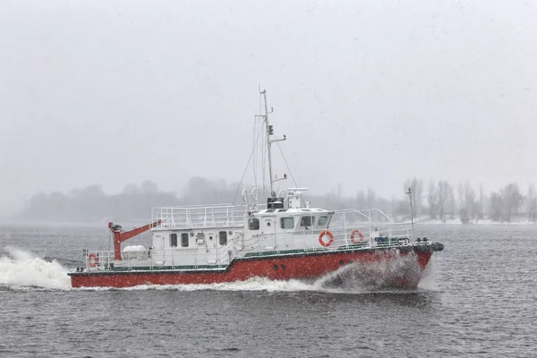 Test the motor boat on the Kama River in the late fall in snowfa