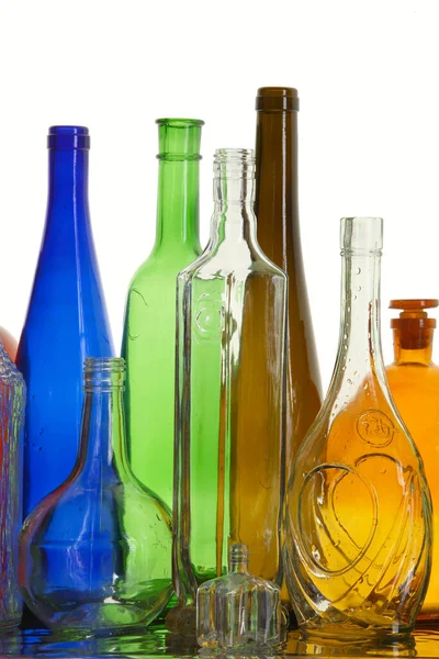 Close Clean Transparent Colored Glass Bottles Different Shapes Mirror Surface — Stock Photo, Image