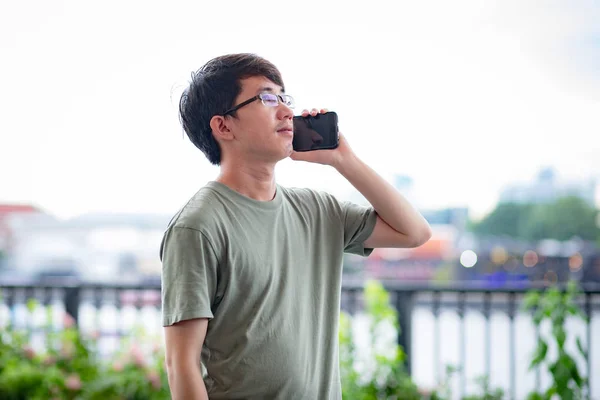 Man calling phone on the riverside view point