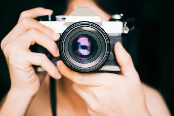 Close up man taking photos with an old vintage film camera
