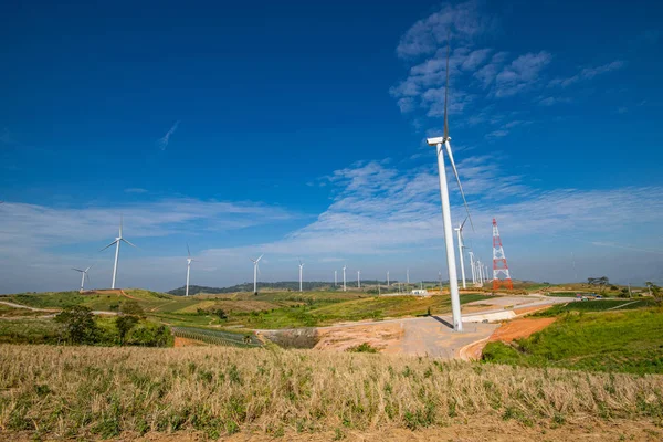 Khao Kho wind turbines on the hill in Phetchabun Province, Thailand on beautiful blue sky day, Landscape of electrical windmills