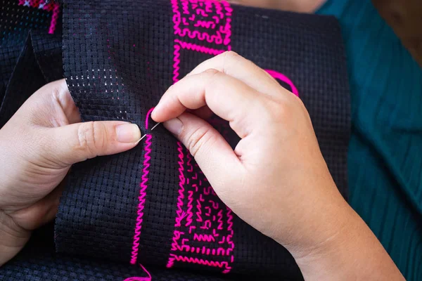 Close Hands Doing Cross Stitch Using Pink Threads Black Cloth — Stock Photo, Image