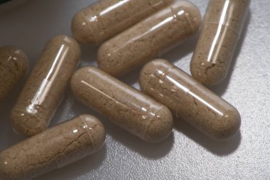 Vejetaryen kapsülleri beyaz masaya bırakılmış.