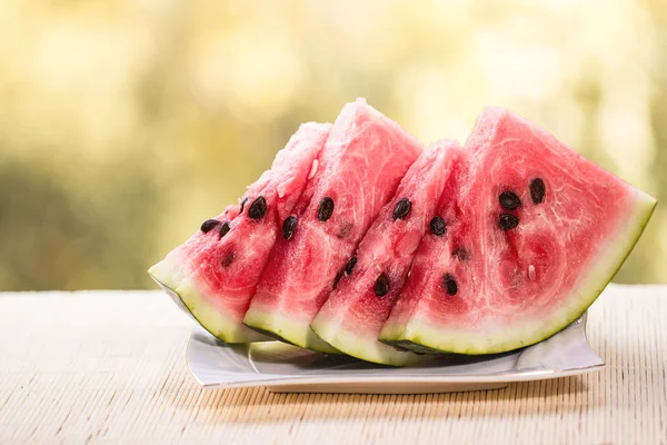 Fresh ripe sliced watermelon on wooden rustic background — Stock Photo, Image