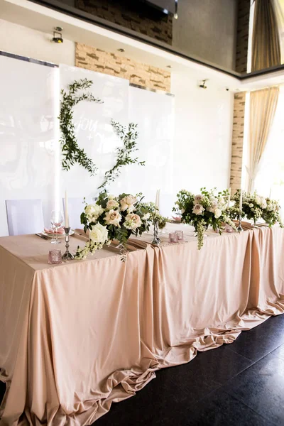 Side view of the presidium with fresh flowers of the newlyweds at the wedding