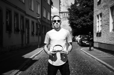 Elinde kulaklık olan bir adamın portresi, kameraya bak. DJ 'in siyah beyaz fotoğrafı.