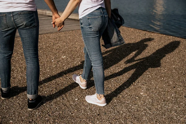 ロマンチックなカップルの近くに手を取り 海岸沿いを歩く 家族の足と手に焦点を当てる — ストック写真