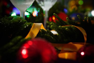 İki bardak şampanya ile arka planda bir Noel dekorasyonu         