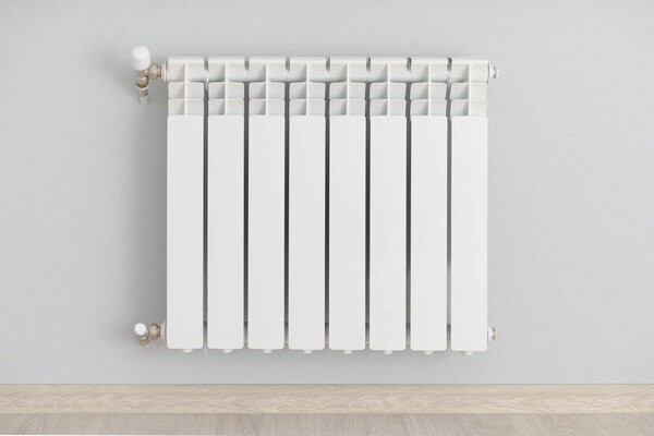 white steel heating radiator on the wall with blue wallpaper