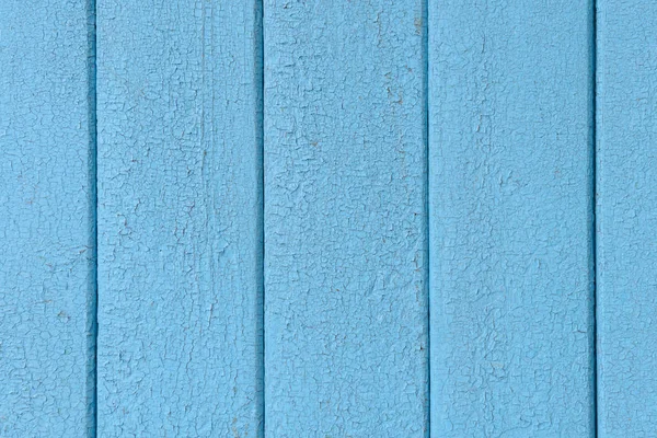 Деревянные вертикальные доски с потрескавшейся старой синей краской — стоковое фото