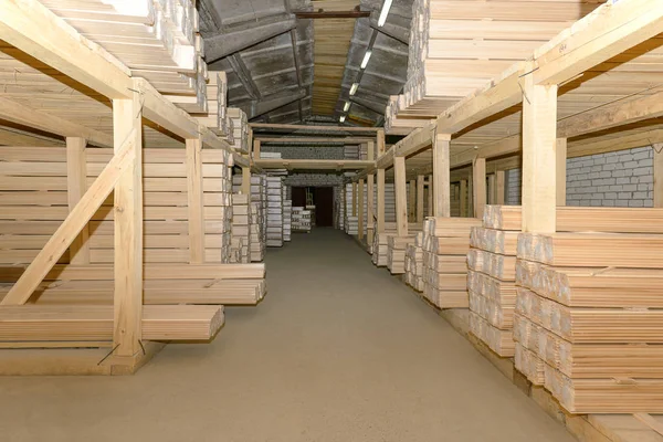 Lumber warehouse with shelves filled with linden lining — Stock Photo, Image