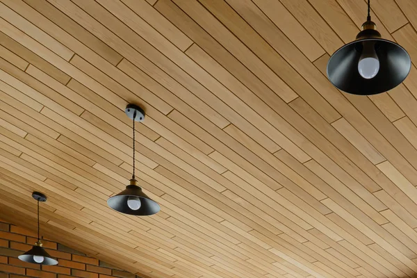 Ceiling lights on a wooden ceiling in a new clean room